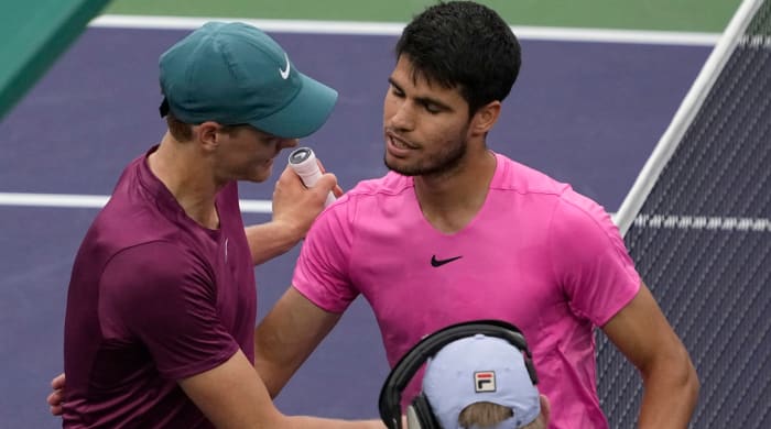Jannik Sinner, of Italy, left, talks with Carlos Alcaraz, of Spain, after Alcarz defeated Sinner.